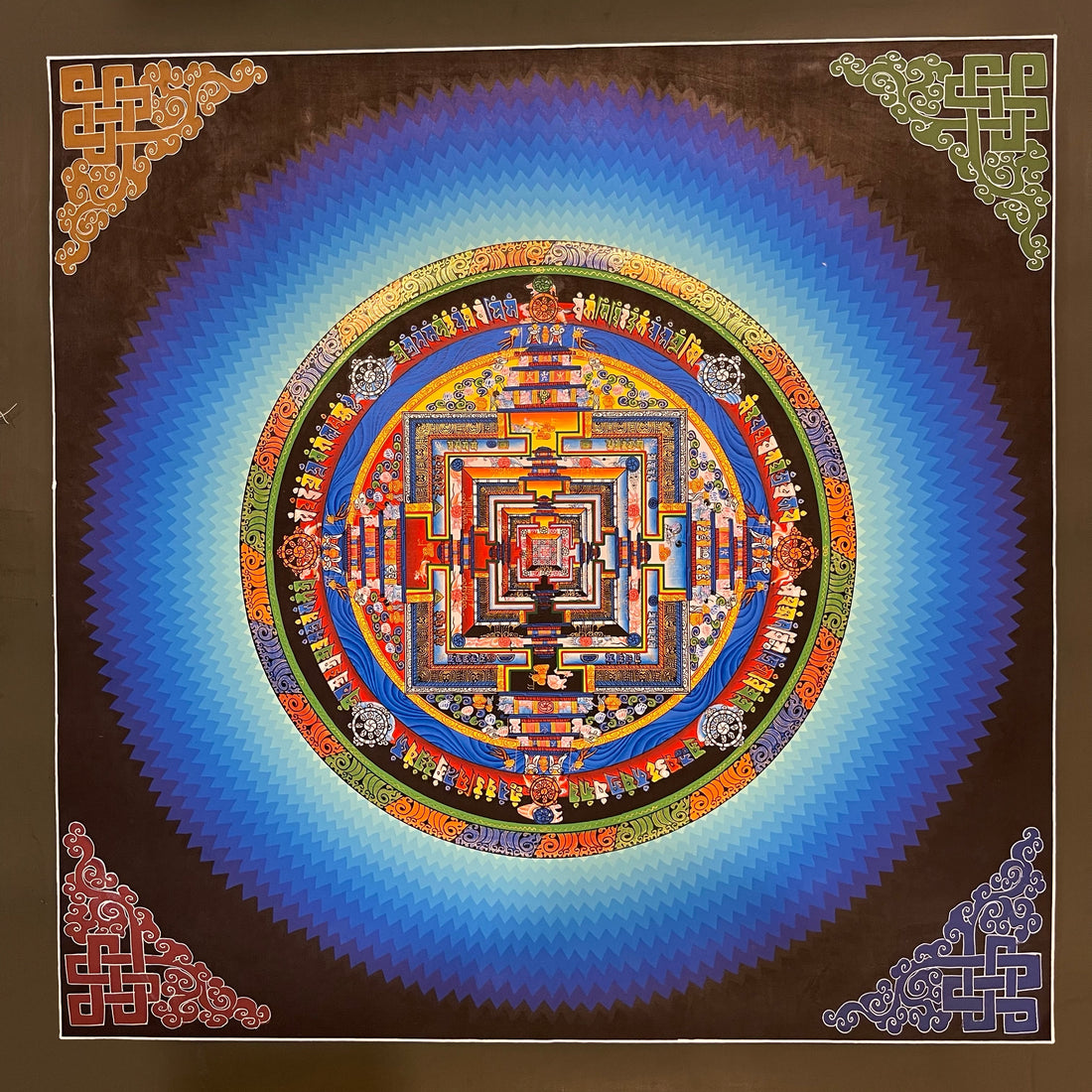 Kalachakra Mandala thangka, 45×45 cm: Kalachakra palace mandala surrounded by zigzag blue rays, with endless knots in the corners