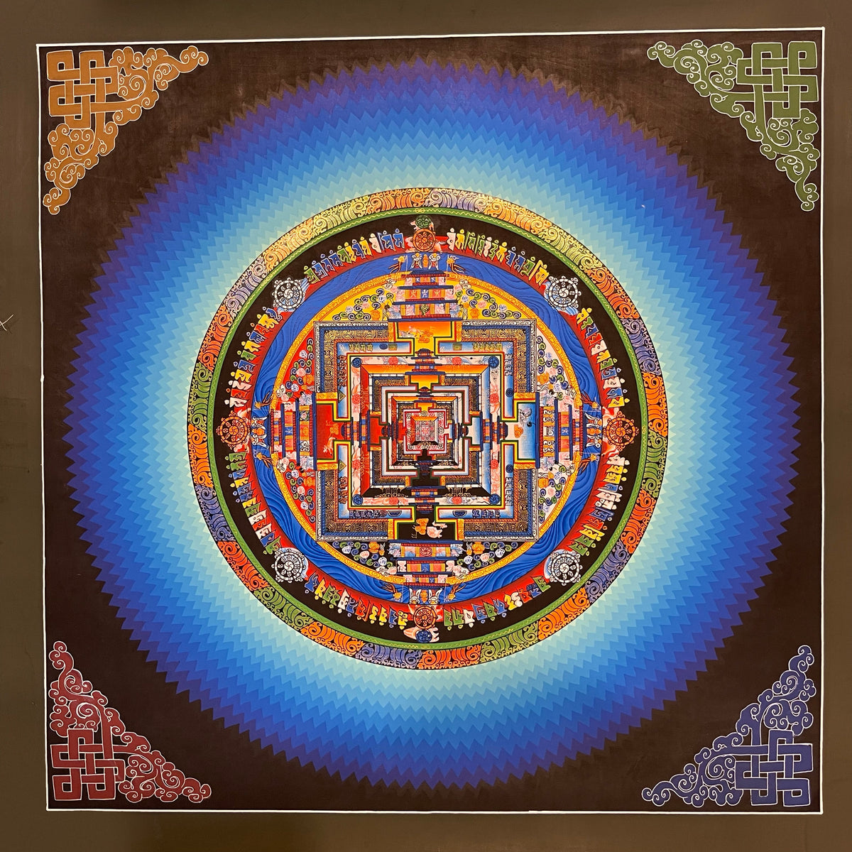 Kalachakra Mandala thangka, 45×45 cm: Kalachakra palace mandala surrounded by zigzag blue rays, with endless knots in the corners