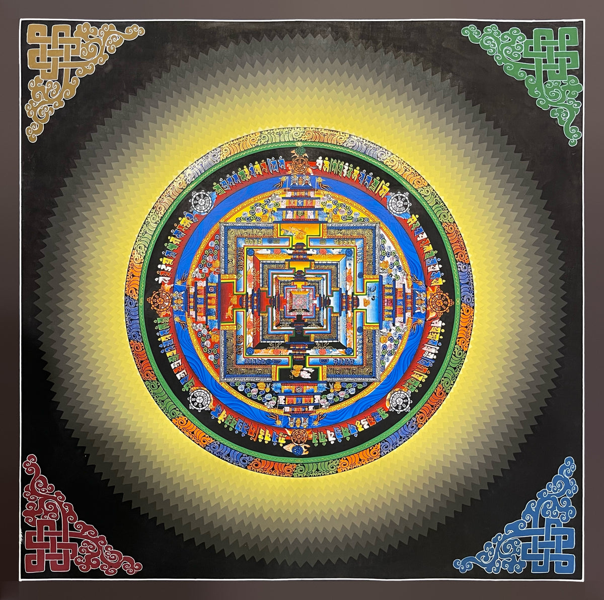 Kalachakra Mandala thangka, 45×45 cm: Kalachakra palace mandala inside a halo of yellow zigzag rays on black, with endless knots in the corners