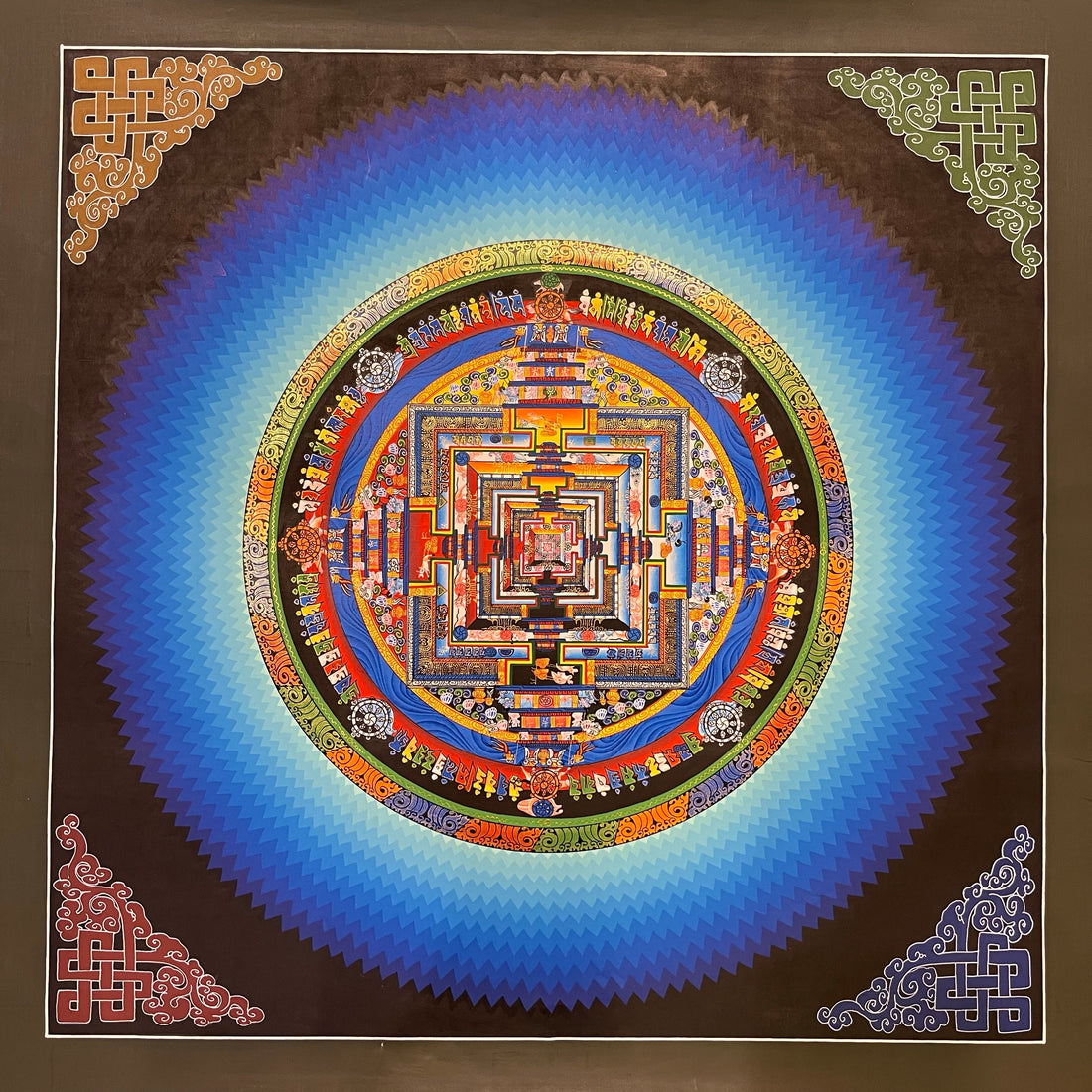 Kalachakra Mandala thangka, 45×45 cm: Kalachakra palace mandala surrounded by zigzag blue rays, with endless knots in the corners
