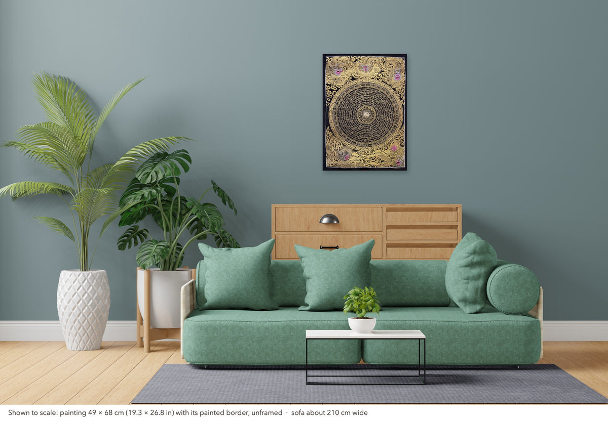 Dragon Mantra Mandala thangka shown to scale in a living room, unframed, above a sofa about 210 cm wide (49×68 cm)