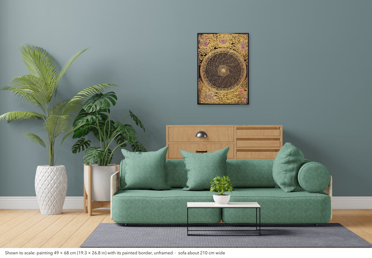Dragon Mantra Mandala thangka shown to scale in a living room, unframed, above a sofa about 210 cm wide (49×68 cm)