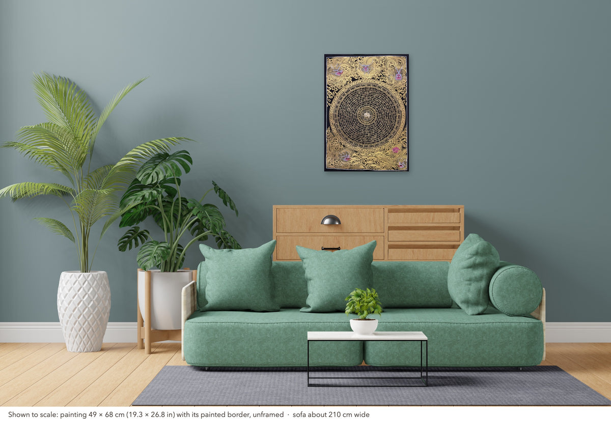 Dragon Mantra Mandala thangka shown to scale in a living room, unframed, above a sofa about 210 cm wide (49×68 cm)