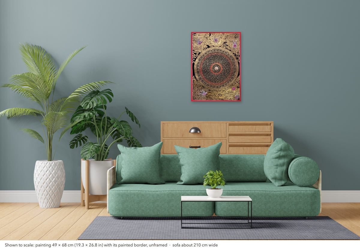 Dragon Mantra Mandala thangka shown to scale in a living room, unframed, above a sofa about 210 cm wide (49×68 cm)