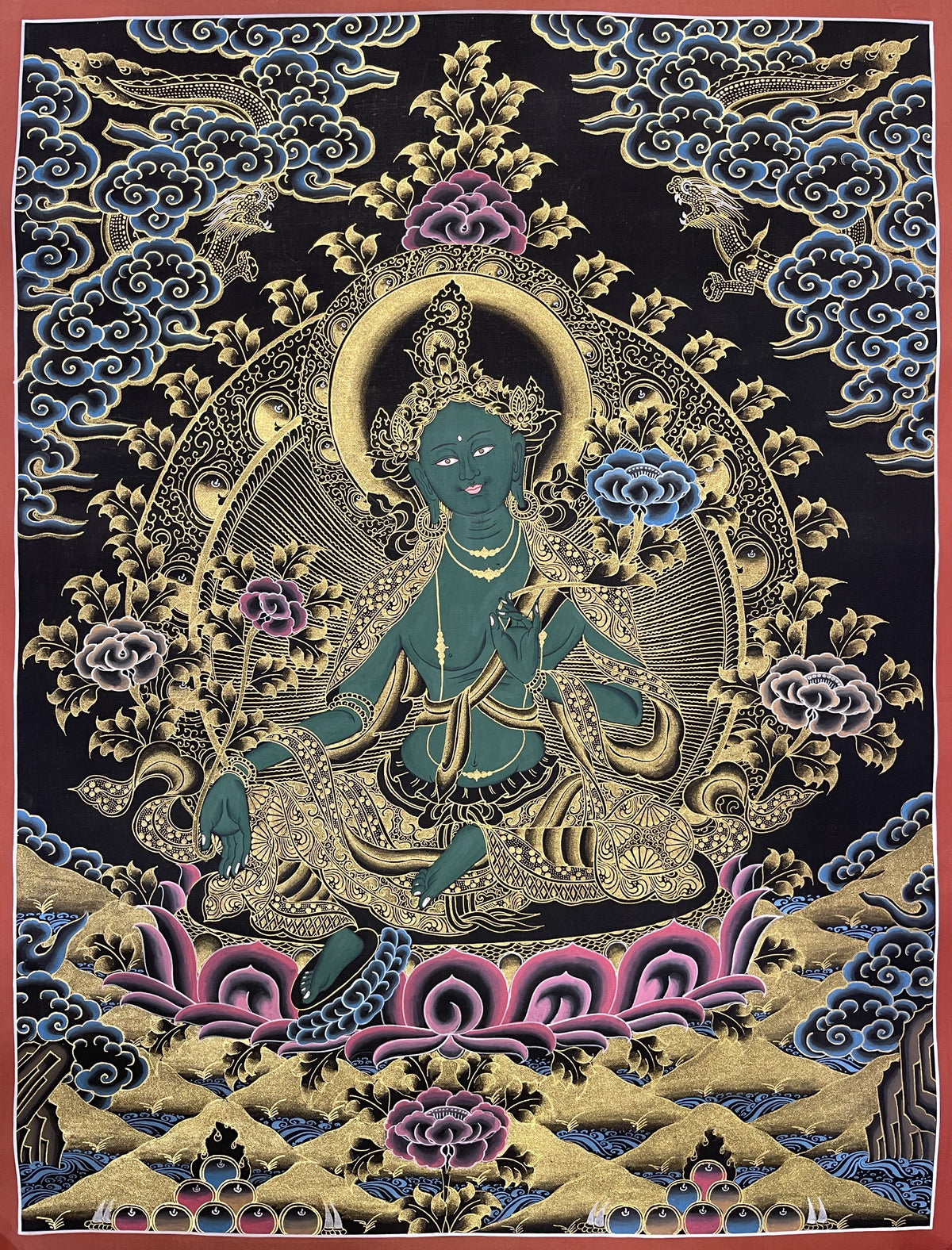 Green Tara thangka, 51×66 cm: Green Tara in gold-coloured line work on black, with dragons in blue clouds above