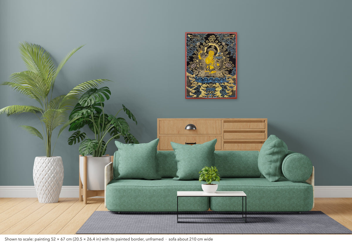 Manjushri thangka shown to scale in a living room, unframed, above a sofa about 210 cm wide (52×67 cm)