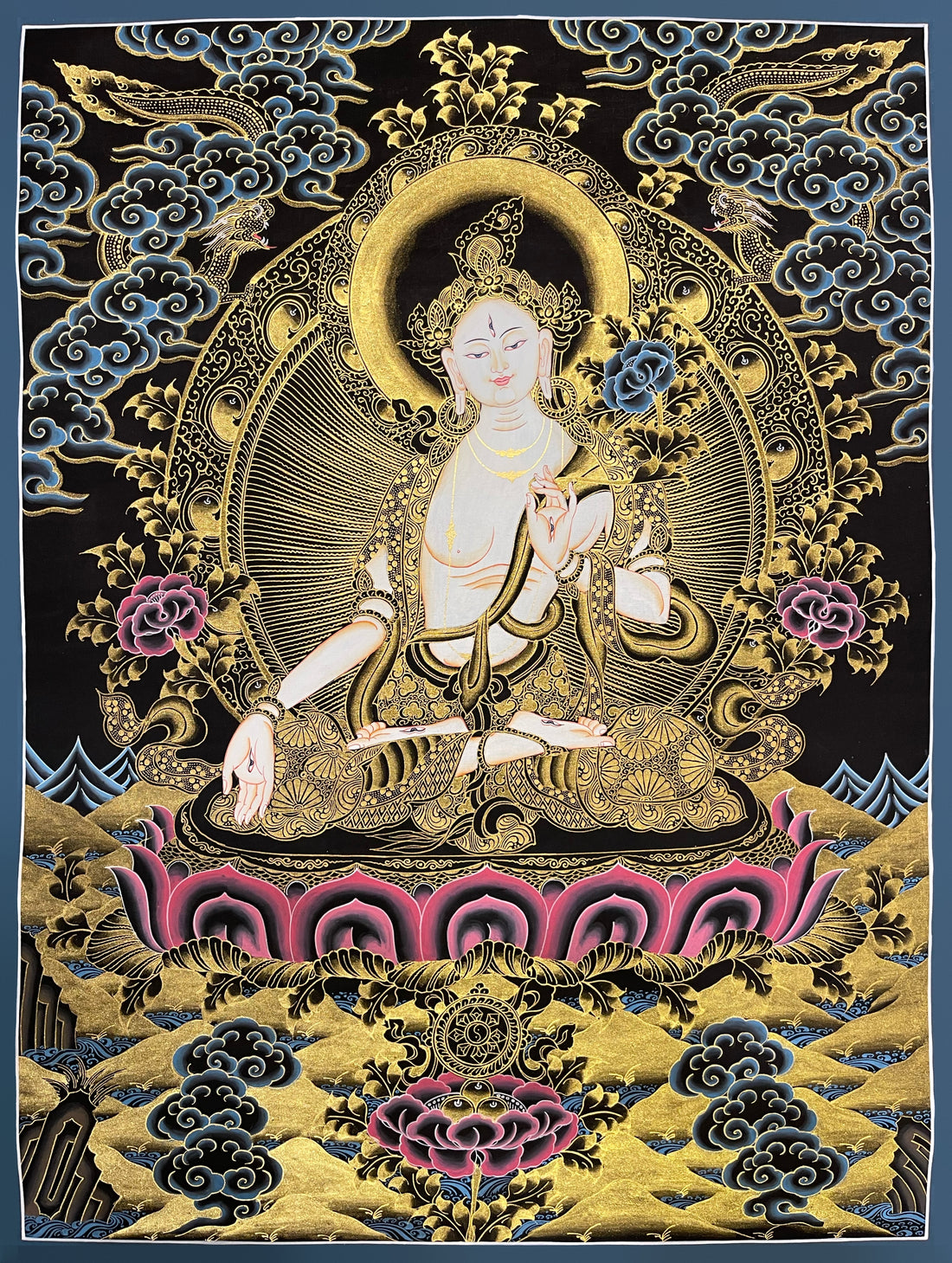 White Tara thangka, 52×67 cm: White Tara in black and gold-coloured line work, with two dragons among blue clouds