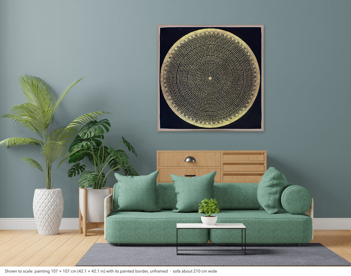 Mantra Mandala thangka shown to scale in a living room, unframed, above a sofa about 210 cm wide (107×107 cm)