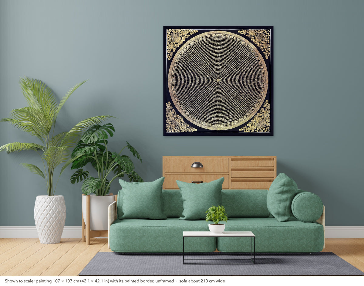 Mantra Mandala thangka shown to scale in a living room, unframed, above a sofa about 210 cm wide (107×107 cm)