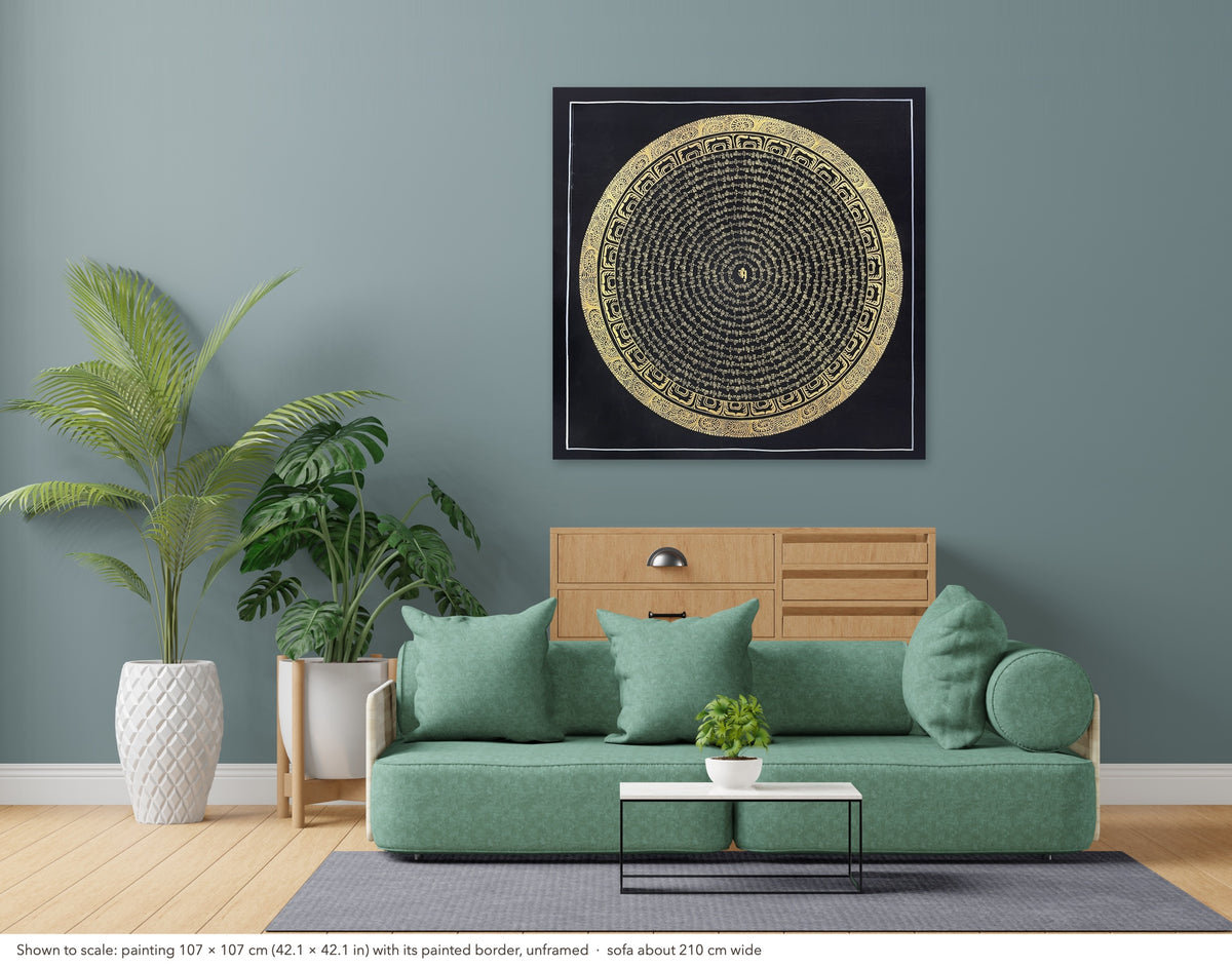 Mantra Mandala thangka shown to scale in a living room, unframed, above a sofa about 210 cm wide (107×107 cm)