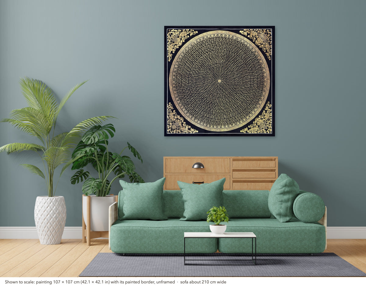 Mantra Mandala thangka shown to scale in a living room, unframed, above a sofa about 210 cm wide (107×107 cm)