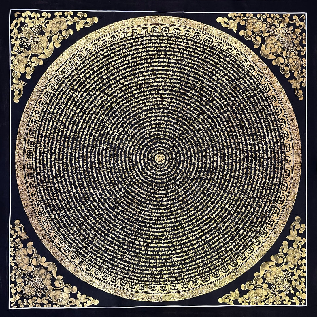 Mantra Mandala thangka, 107×107 cm: concentric rings of gold-coloured mantra script on black, with gold-coloured peonies in the corners