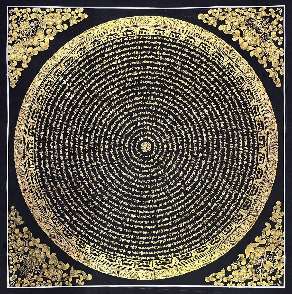 Mantra Mandala thangka, 80×80 cm: concentric rings of gold-coloured mantra script on black, with gold-coloured peonies in the corners