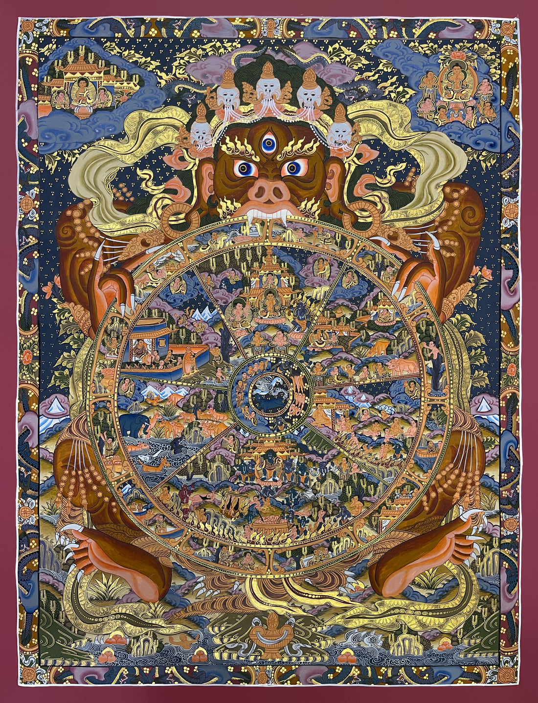Wheel of Life thangka, 63×82 cm: brown Yama holding the Wheel of Life on a dark blue ground, framed by a border of dragons