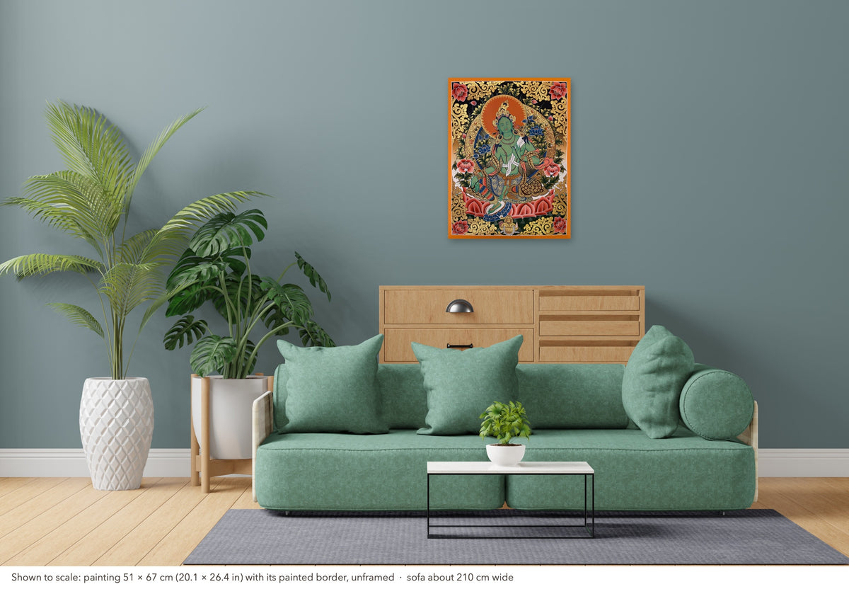Green Tara thangka shown to scale in a living room, unframed, above a sofa about 210 cm wide (51×67 cm)