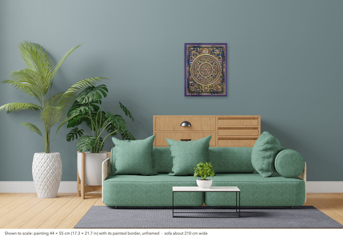 Buddha Mandala thangka shown to scale in a living room, unframed, above a sofa about 210 cm wide (44×55 cm)