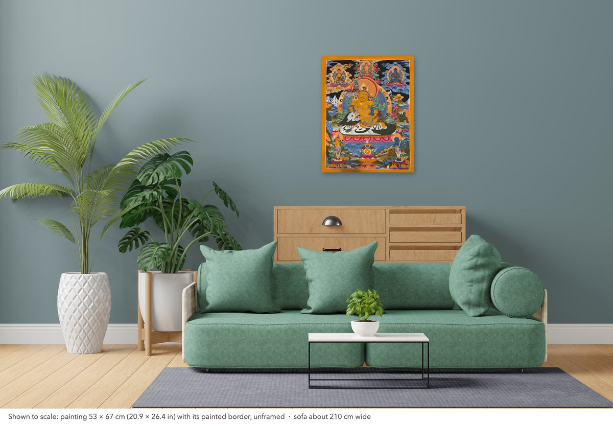Vaishravana thangka shown to scale in a living room, unframed, above a sofa about 210 cm wide (53×67 cm)