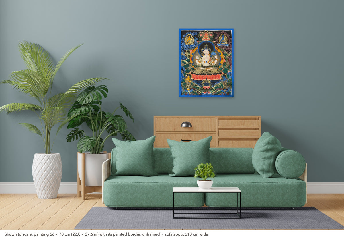 Chenrezig thangka shown to scale in a living room, unframed, above a sofa about 210 cm wide (56×70 cm)