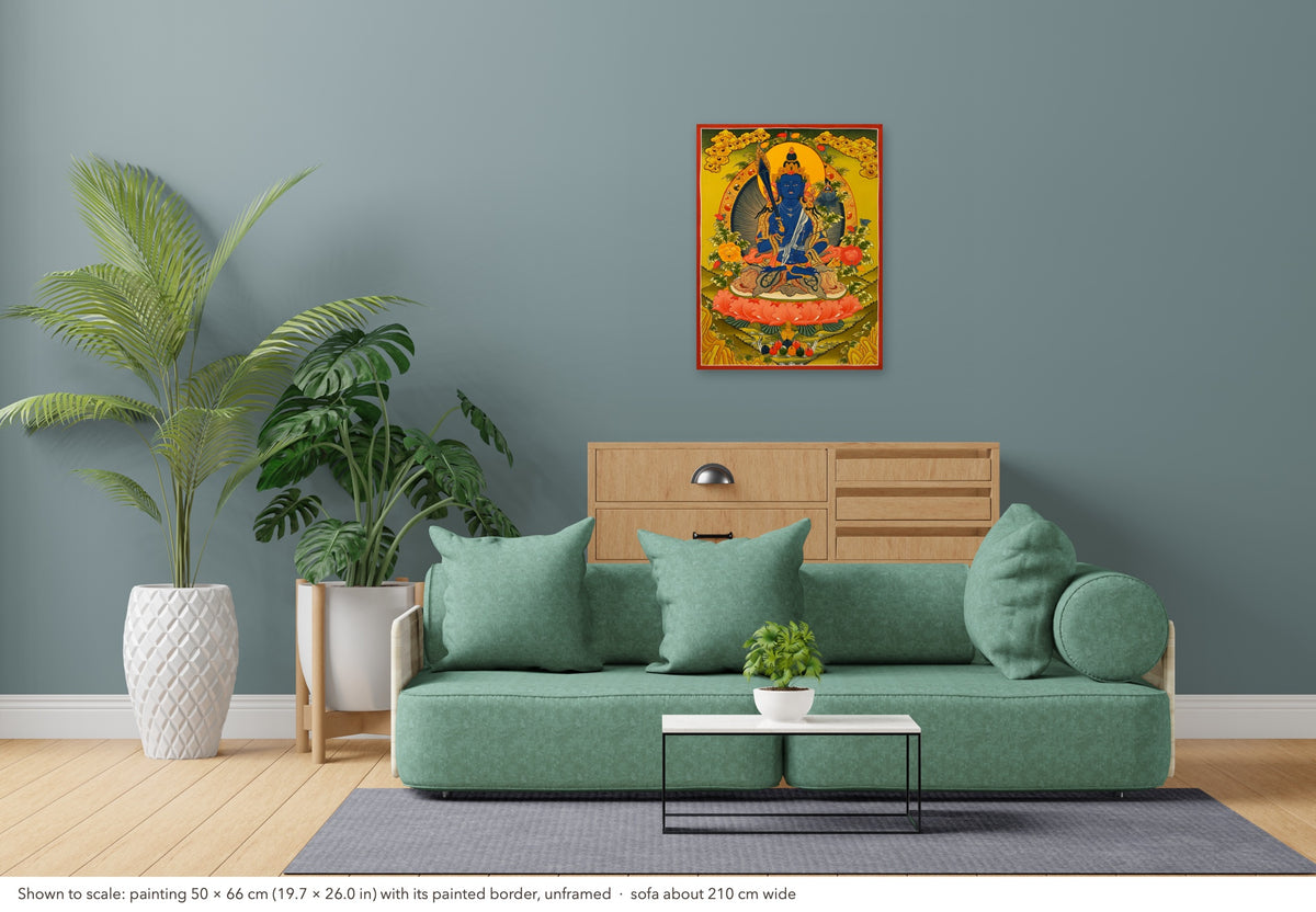 Manjushri thangka shown to scale in a living room, unframed, above a sofa about 210 cm wide (50×66 cm)