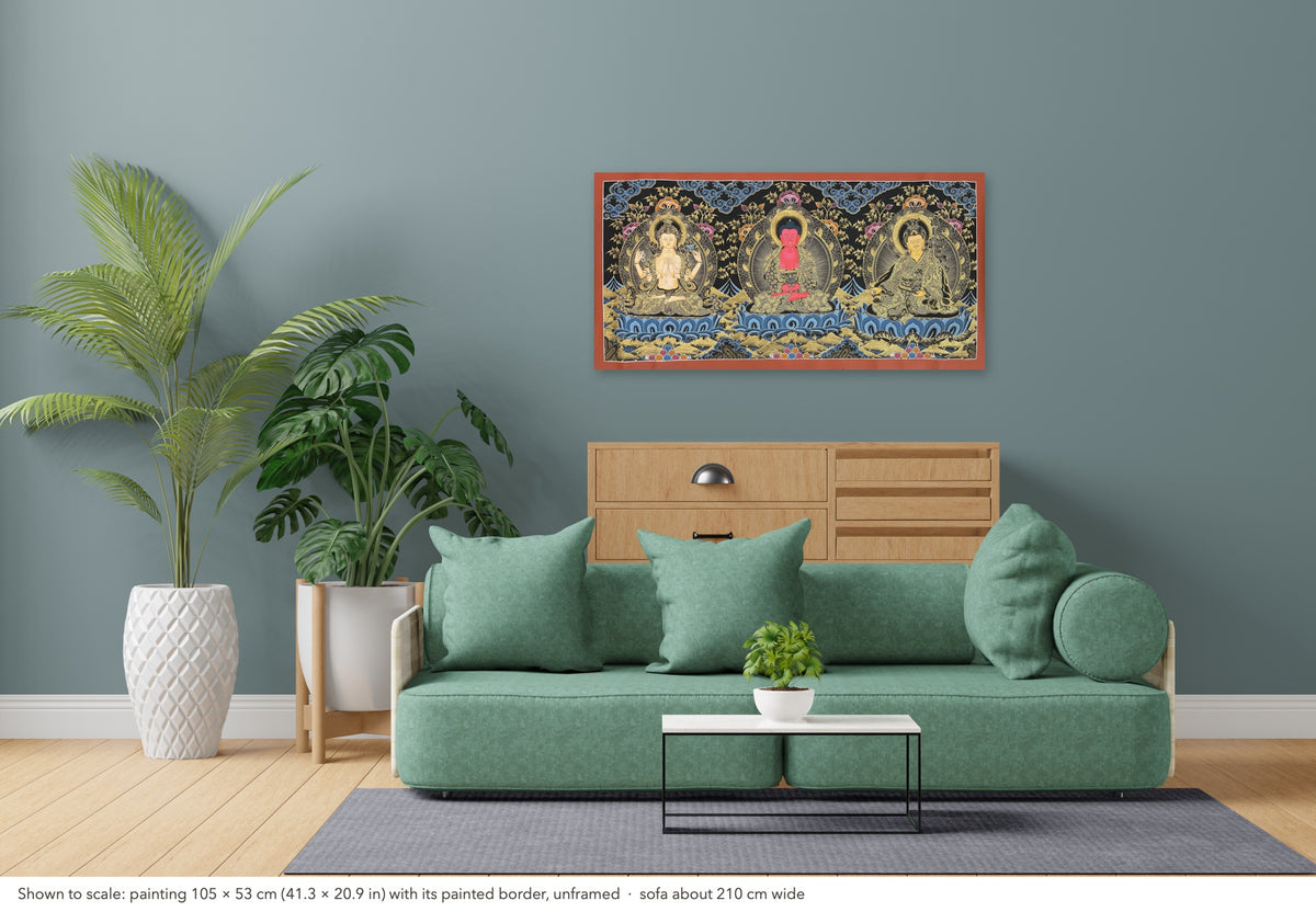 Amitabha Buddha, Chenrezig & Padmasambhava thangka shown to scale in a living room, unframed, above a sofa about 210 cm wide (105×53 cm)