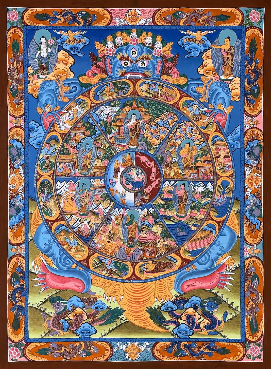 Wheel of Life thangka, 45×60 cm: blue Yama holding the Wheel of Life on deep blue, framed by an orange border of dragons