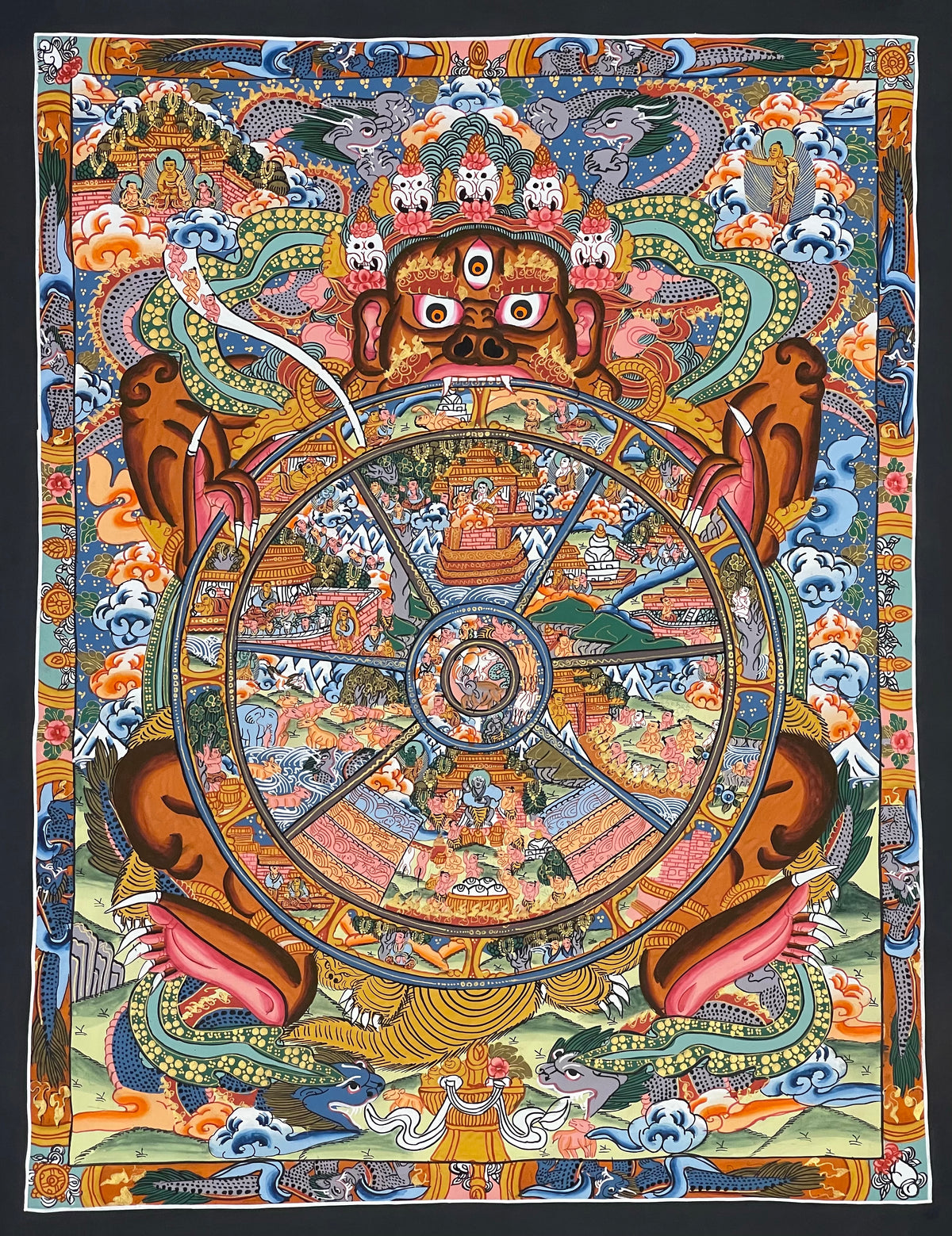 Wheel of Life thangka, 43×53 cm: brown Yama holding a densely painted Wheel of Life, inside a border of dragons