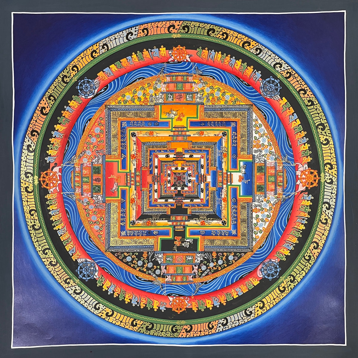 Kalachakra Mandala thangka, 55×55 cm: Kalachakra palace mandala with rings of mantra syllables and dharma wheels on a deep blue ground