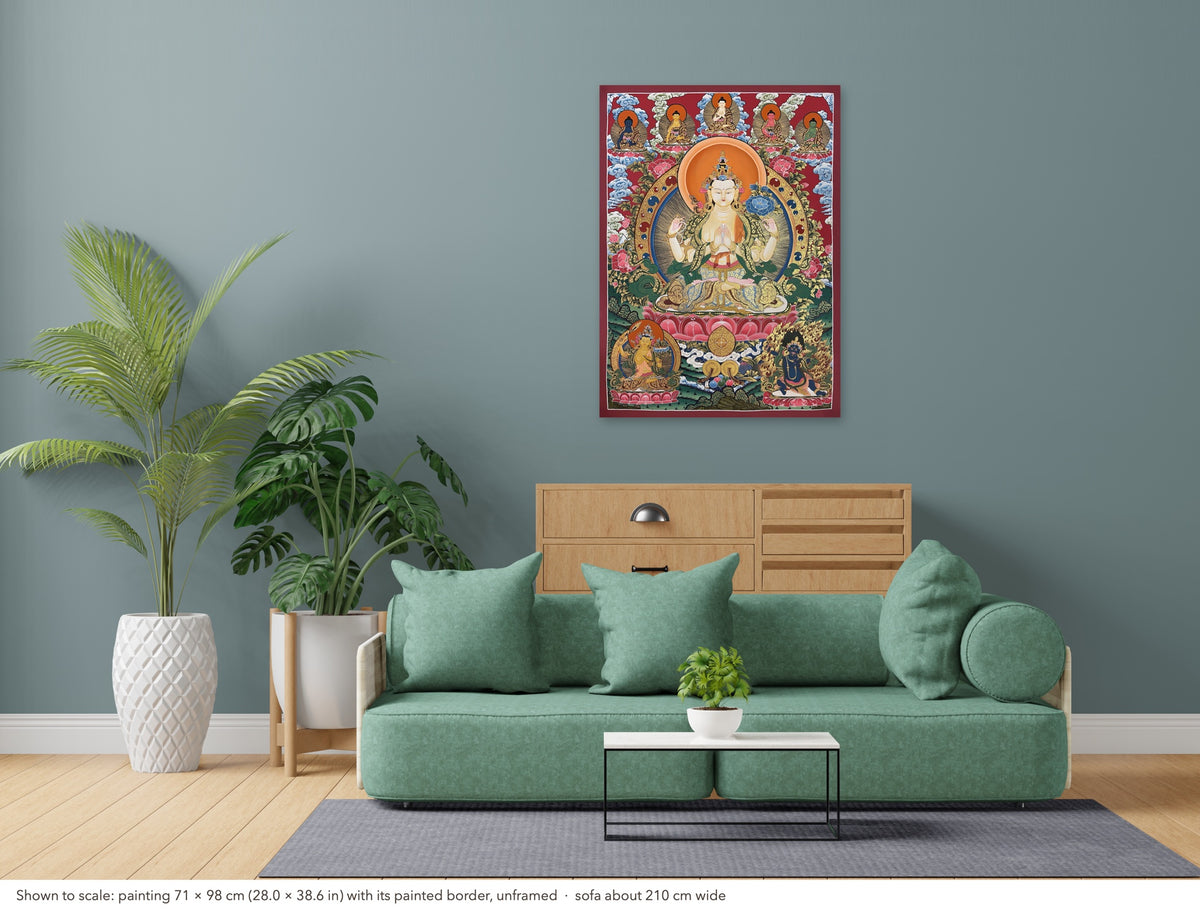Chenrezig thangka shown to scale in a living room, unframed, above a sofa about 210 cm wide (71×98 cm)