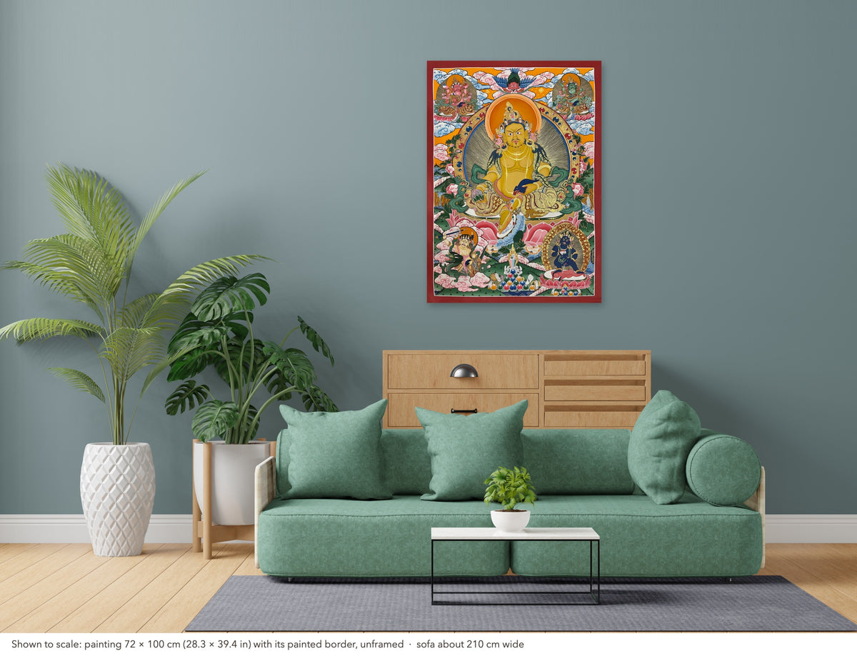 Jambhala thangka shown to scale in a living room, unframed, above a sofa about 210 cm wide (72×100 cm)