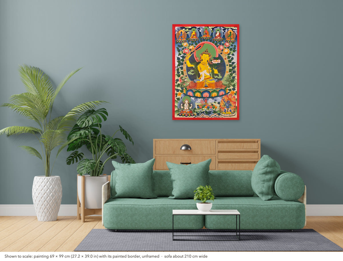 Manjushri thangka shown to scale in a living room, unframed, above a sofa about 210 cm wide (69×99 cm)