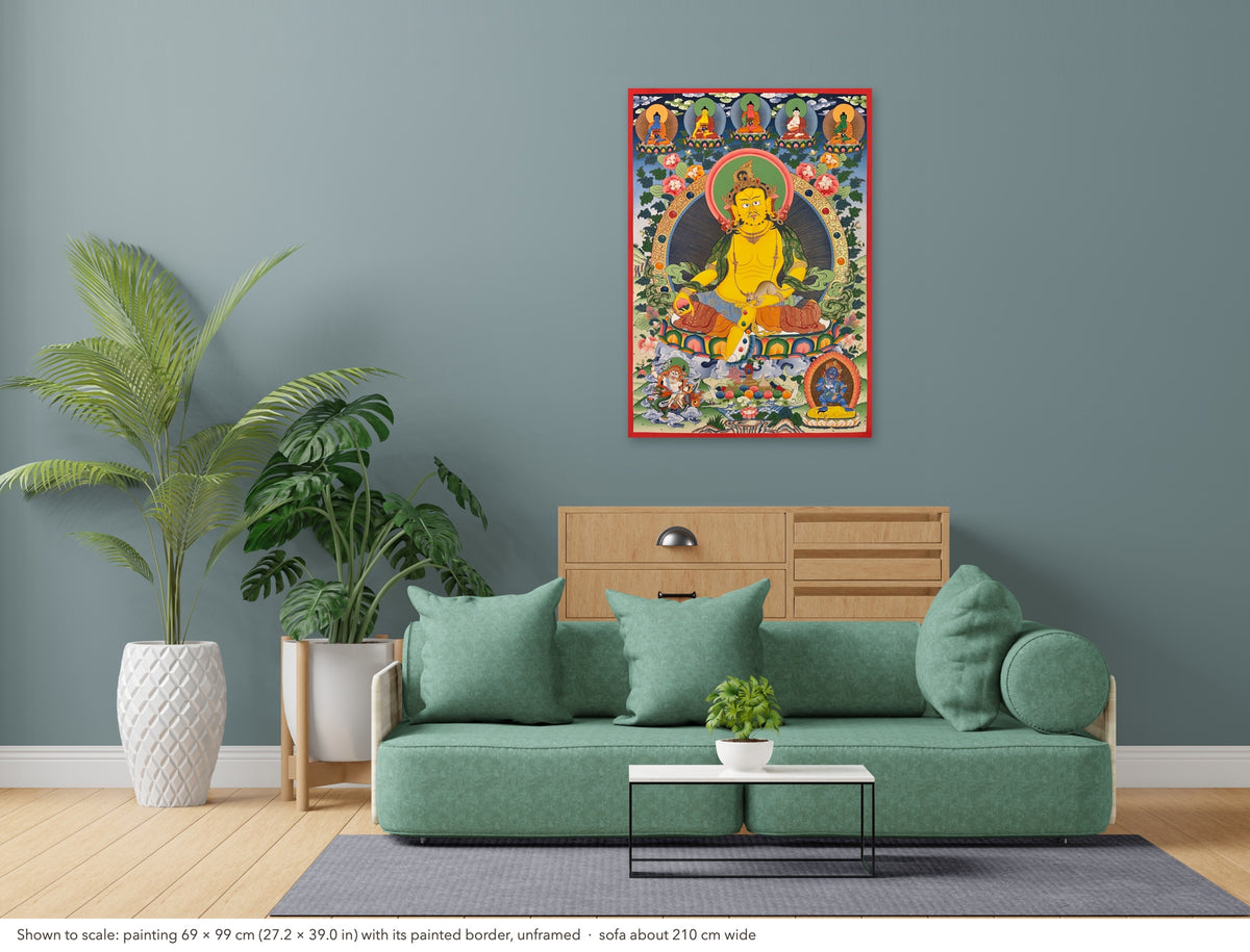 Jambhala thangka shown to scale in a living room, unframed, above a sofa about 210 cm wide (69×99 cm)