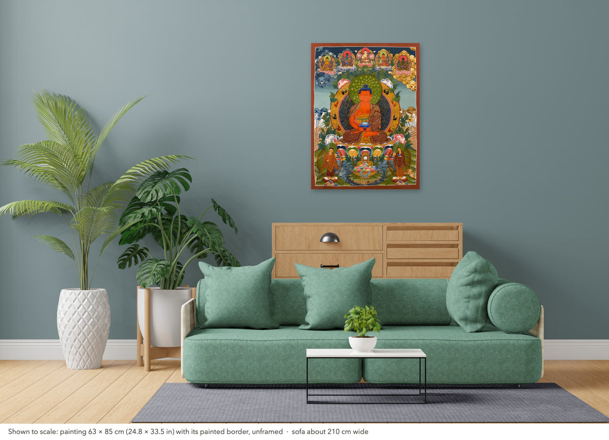Amitabha Buddha thangka shown to scale in a living room, unframed, above a sofa about 210 cm wide (63×85 cm)