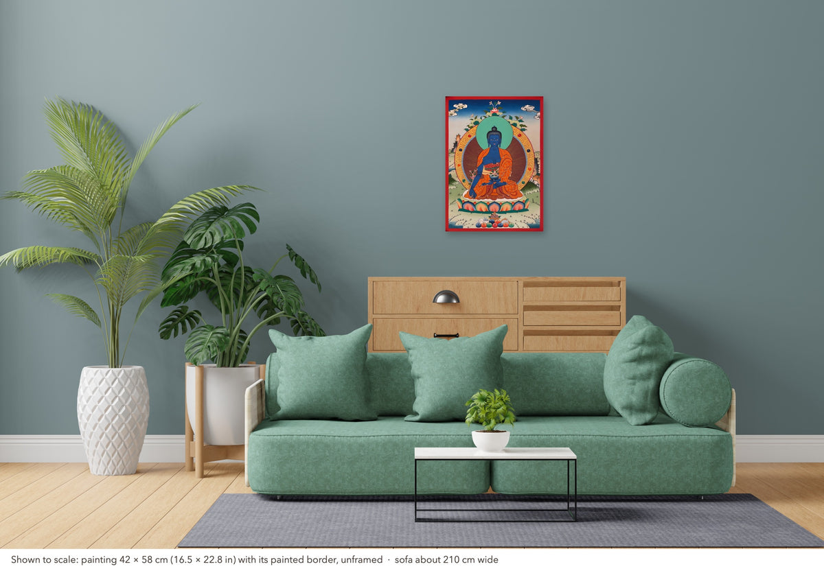 Medicine Buddha thangka shown to scale in a living room, unframed, above a sofa about 210 cm wide (42×58 cm)