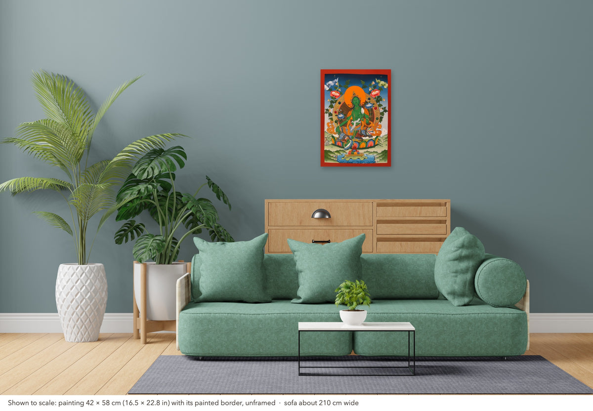 Green Tara thangka shown to scale in a living room, unframed, above a sofa about 210 cm wide (42×58 cm)