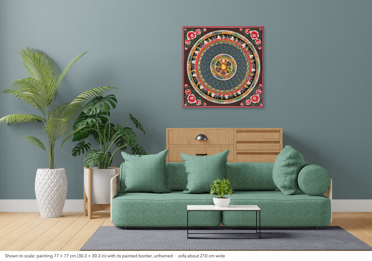 Mantra Mandala thangka shown to scale in a living room, unframed, above a sofa about 210 cm wide (77×77 cm)