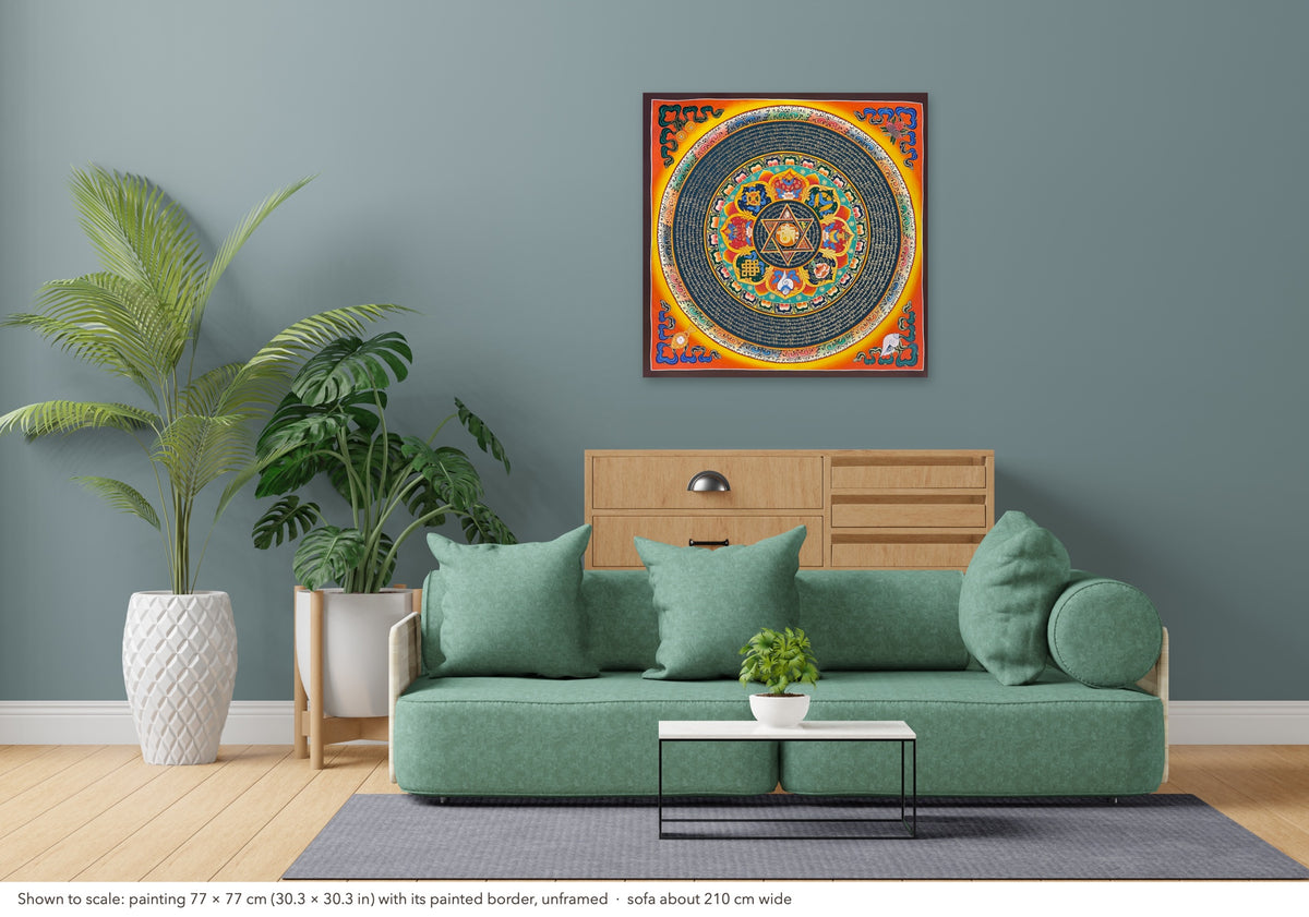 Mantra Mandala thangka shown to scale in a living room, unframed, above a sofa about 210 cm wide (77×77 cm)
