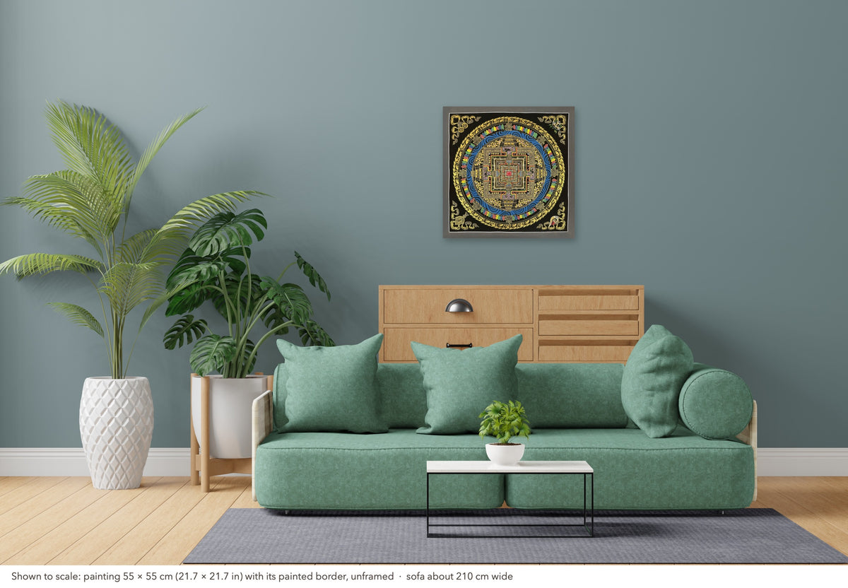 Kalachakra Mandala thangka shown to scale in a living room, unframed, above a sofa about 210 cm wide (55×55 cm)