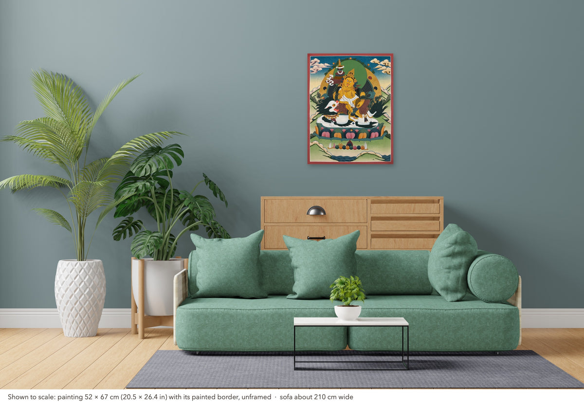 Vaishravana thangka shown to scale in a living room, unframed, above a sofa about 210 cm wide (52×67 cm)