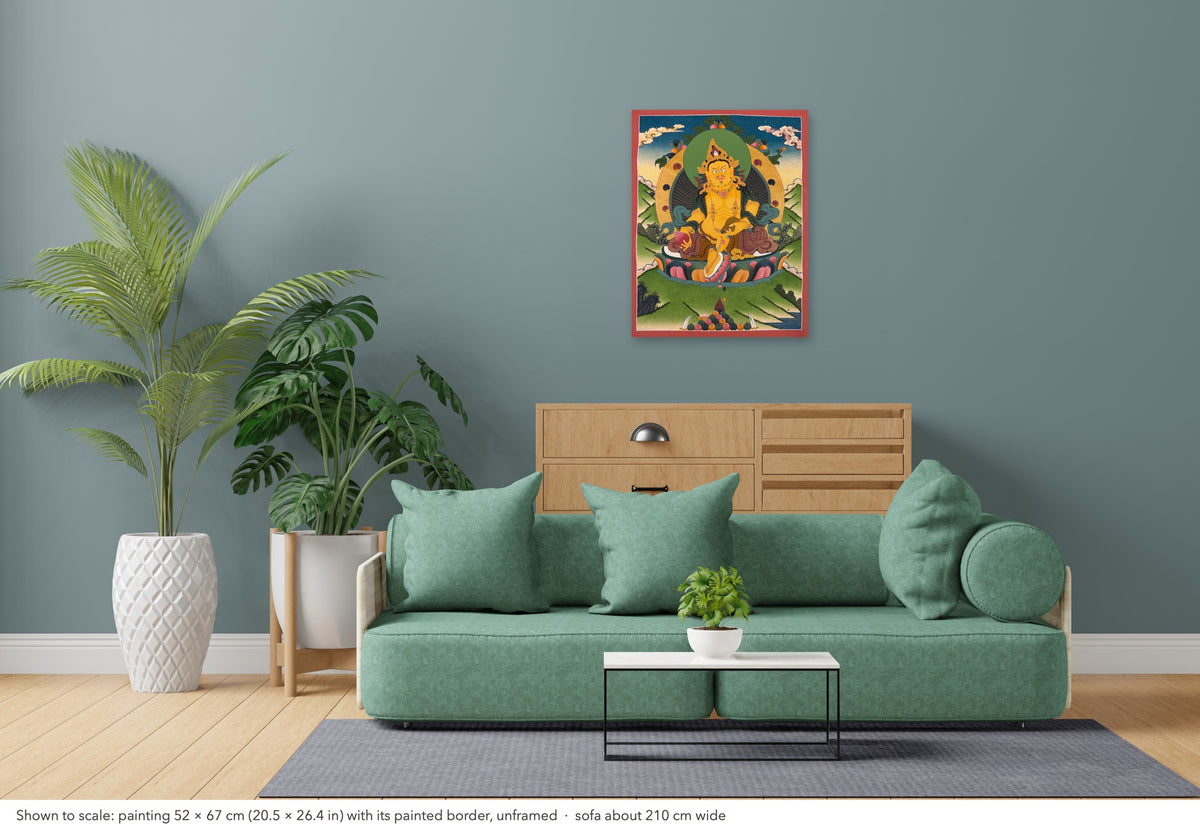 Jambhala thangka shown to scale in a living room, unframed, above a sofa about 210 cm wide (52×67 cm)