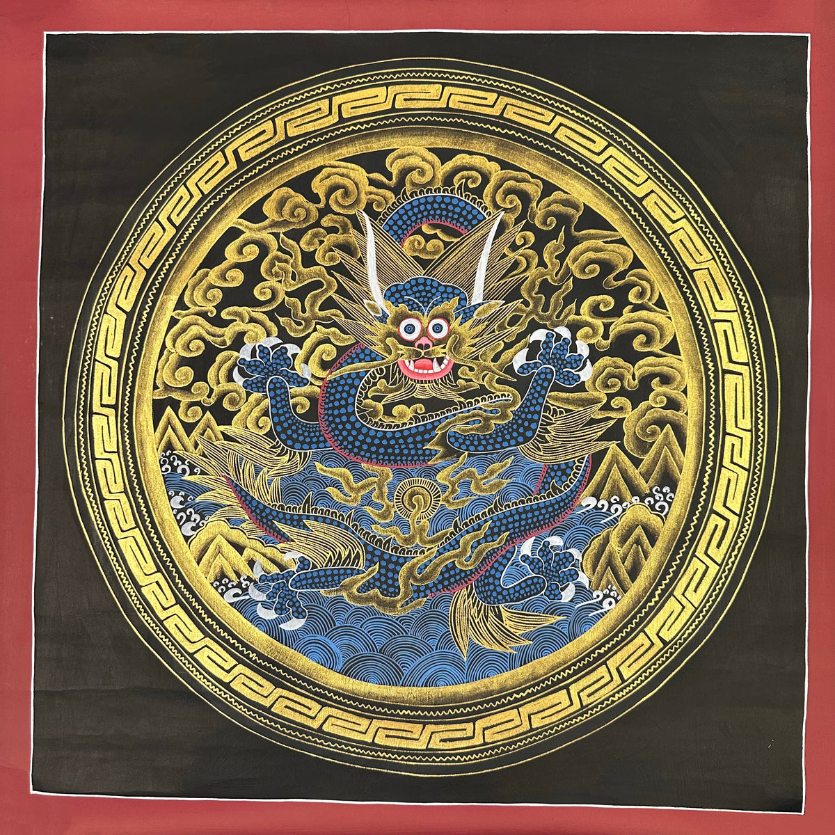 Dragon Mandala thangka, 55×55 cm: a blue dragon reaching for a flaming pearl in gold-coloured clouds, inside a key-pattern circle on black