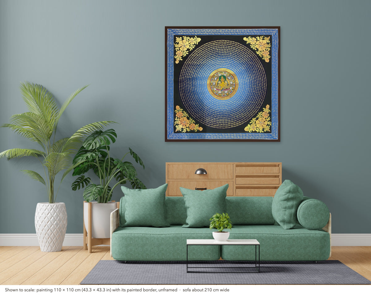 Jambhala Mantra Mandala thangka shown to scale in a living room, unframed, above a sofa about 210 cm wide (110×110 cm)