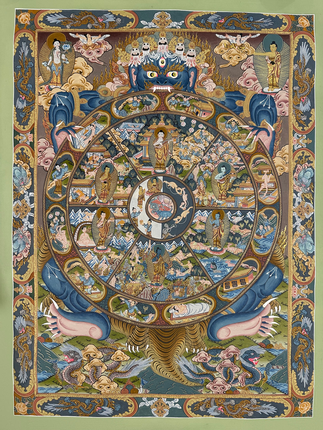 Wheel of Life thangka, 40×61 cm: blue Yama holding the Wheel of Life with a Buddha in each realm, framed by a border of dragons