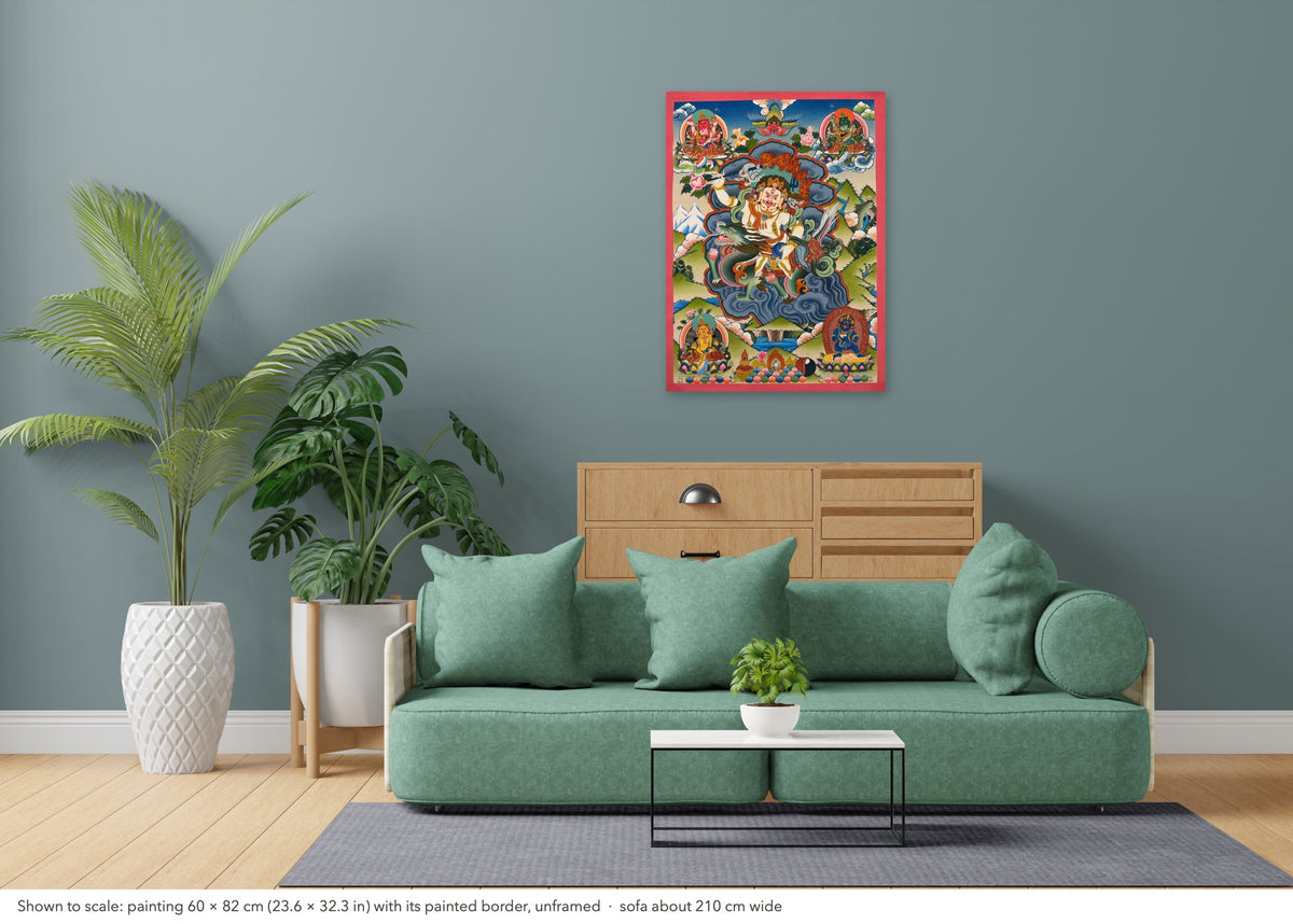 White Jambhala thangka shown to scale in a living room, unframed, above a sofa about 210 cm wide (60×82 cm)