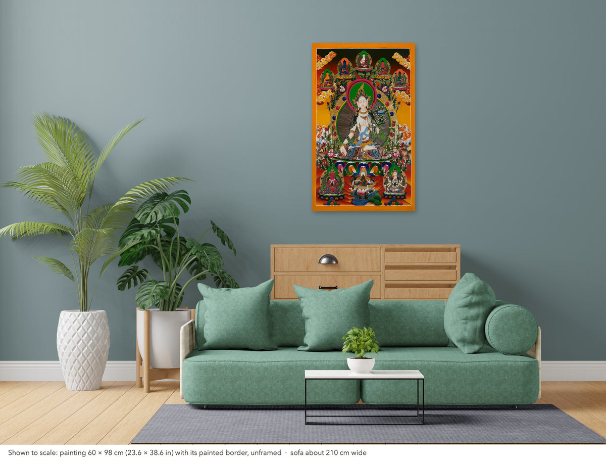 White Tara thangka shown to scale in a living room, unframed, above a sofa about 210 cm wide (60×98 cm)