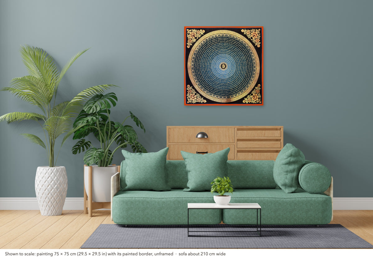 Mantra Mandala thangka shown to scale in a living room, unframed, above a sofa about 210 cm wide (75×75 cm)