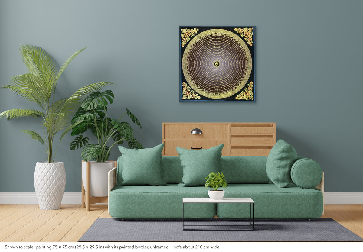 Mantra Mandala thangka shown to scale in a living room, unframed, above a sofa about 210 cm wide (75×75 cm)