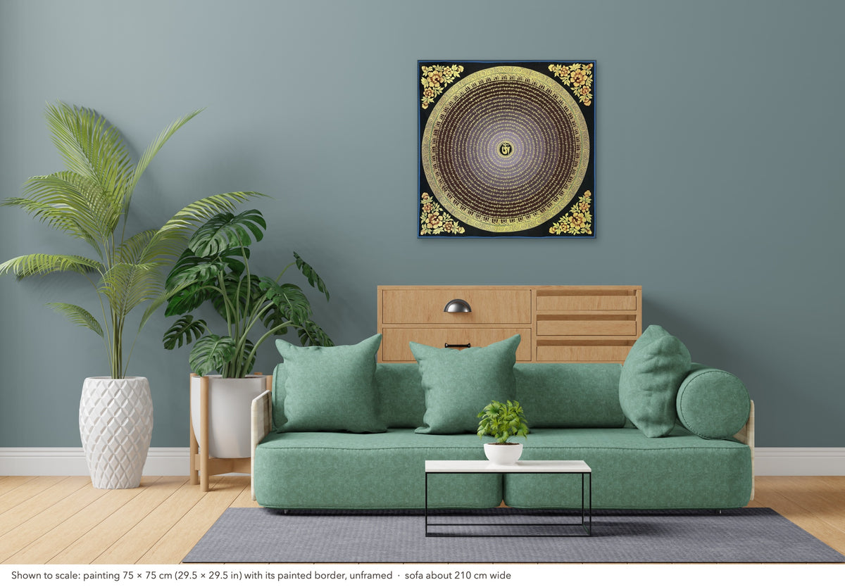 Mantra Mandala thangka shown to scale in a living room, unframed, above a sofa about 210 cm wide (75×75 cm)