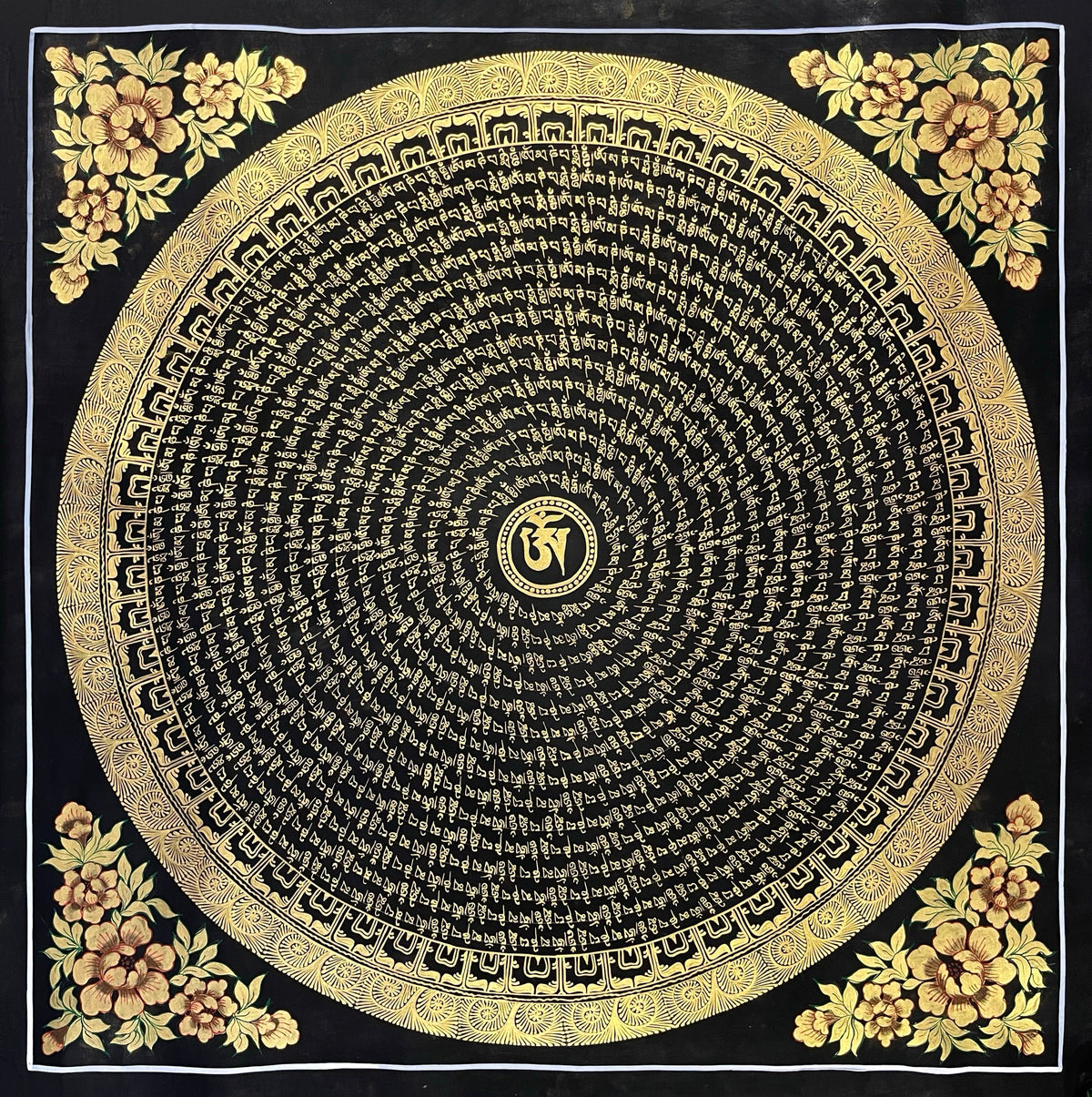 Mantra Mandala thangka, 76×76 cm: a spiral of gold-coloured mantra script on black around a central Om, with gold-coloured peonies in the corners